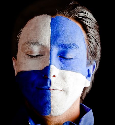 Man with a blue and white flag painted on his face