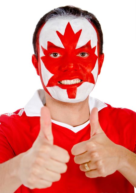 Happy Canadian man with the flag painted on his face and thumbs up- isolated