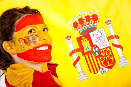 Spanish woman with the flag behind her and paint on her face
