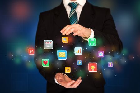 elegant-businessman-holding-colorful-mixed-media-775990975 Elegant businessman holding colorful mixed media icons