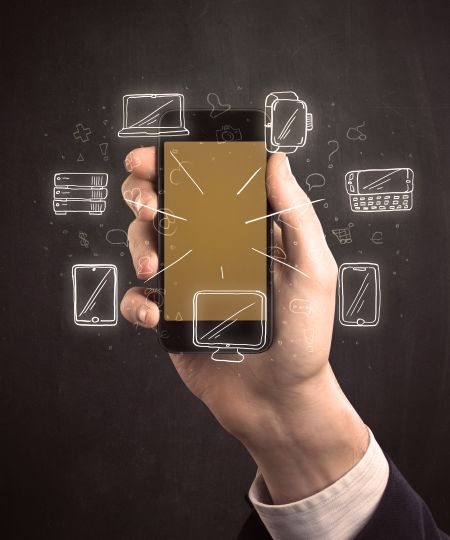 Caucasian hand in business suit holding a smartphone with hand-drawn icons