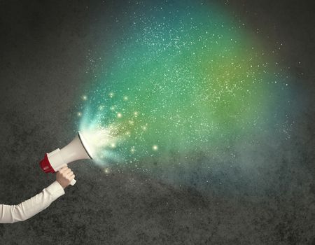 Caucasian business hand holding megaphone with white sparkles on a grunge background