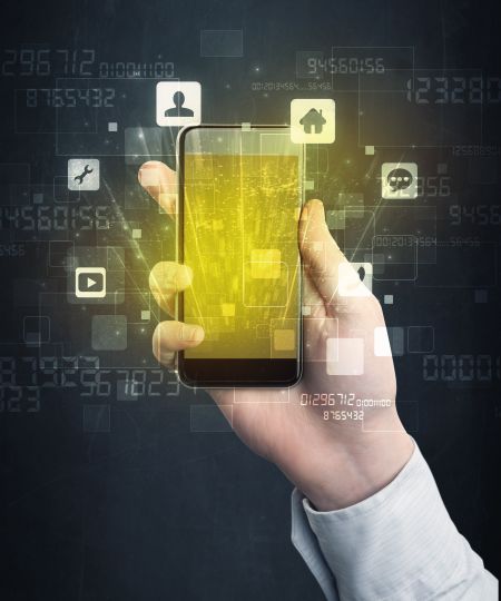 Caucasian hand in business suit holding a smartphone with golden-yellow holographic screen