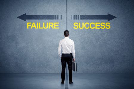 Businessman standing in front of success and failure arrow concept on grungy background