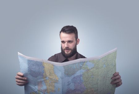 Handsome young man holding map 