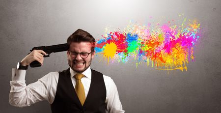 Man shoots his head with gun and colorful splotch are coming out from his head