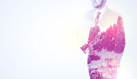  Young businessman in suit standing with sunny snowy mountain and trees graphic.