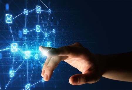 Female finger touching a beam of light surrounded by a blue graphic with envelopes