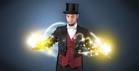 Magician holding his sparkling power between his two hand