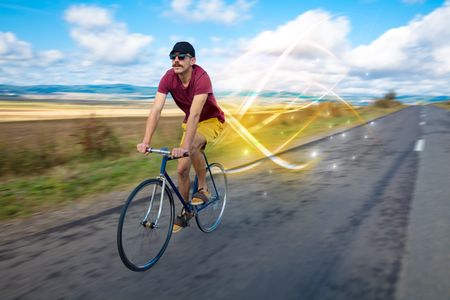 Young cyclist riding bicycle with magical landscape and concept