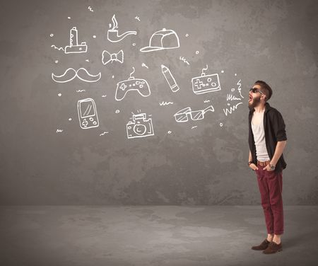 A funny hipster person in casual urban clothing shouting drawn everyday items like camera, tie or pen on city wall concept