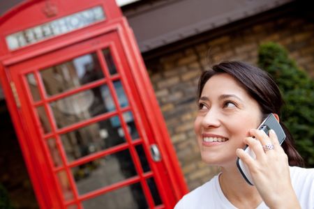 Woman talking on the phone outdoors in London streets