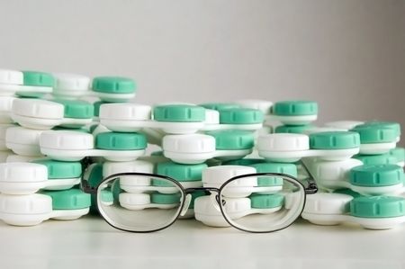 Eyeglasses and many plastic contact-lens cases