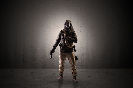 Bad agent in a dark room with arms on his hand and gas mask
