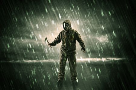 Terrorist in a stormy space with gas mask on his hand and weapons on his arm