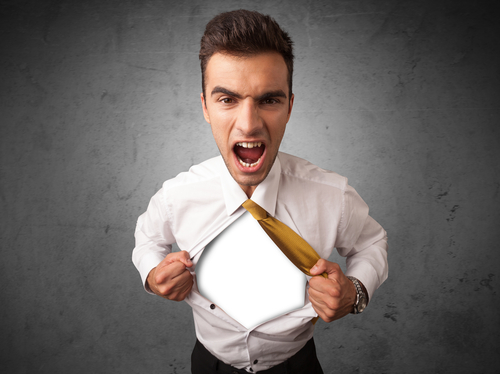 Businessman tearing off his shirt with white copyspace on chest on grungy background