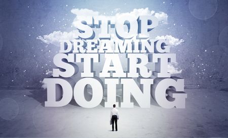 A lazy sales person standing in emty space with huge block letters illustration saying stop dreaming start doing and clouds concept