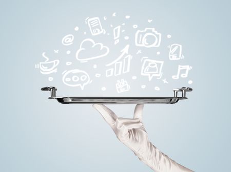 A professional waiter holding a silver plate with drawn communication, business and online media icons in front of a light blue background