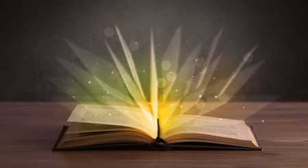 Yellow lights spreading from an open book 