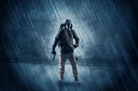 Big peril men in front of a crumbly wall with dangerous stuffs in his hand