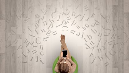 Letters with writer using tablet in a beige chair and an office space

