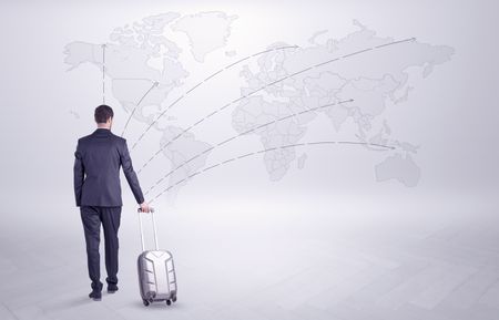 Businessman in dark suit planning his trip in a front of a map
