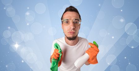 Glittered blue background with male housekeeper and cleaning equipment
