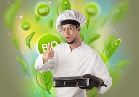 Green bio leaves concept and cook portrait with kitchen tools
