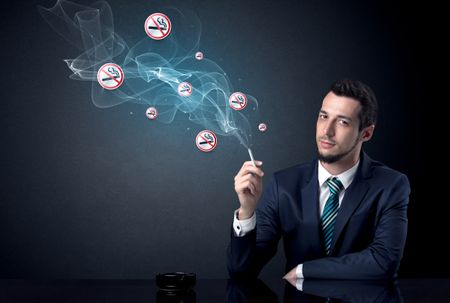 Businessman smoking with floating no smoking signs beside his head.