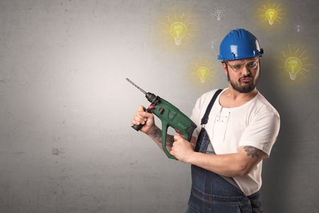 Craftsman with tool and new idea symbol in his hand.