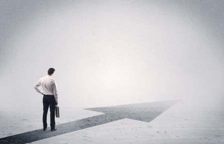 professional-businessman-thinking-standing-black-arrow-787879855 A professional businessman thinking while standing on a black arrow pointing forward in grey space concept