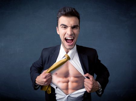 Businessman tearing off his shirt and showing mucular body concept on background