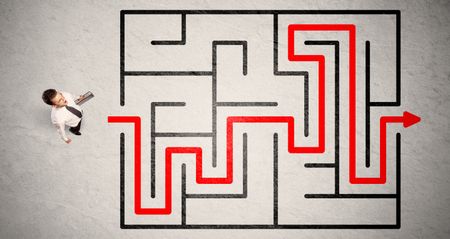 Lost businessman found the way in maze with red arrow on grungy background