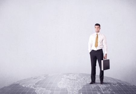 An elegant young male businessman standing on top of the world, pointing up concept with drawn earth map.