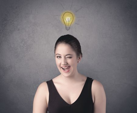 teen-student-girl-funny-facial-expression-787996984 A teen student girl with funny facial expression has a good idea illustrated by a drawn light bulb lighting up above the head on the grey wall background concept.