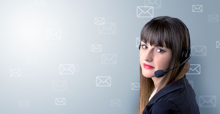 Young female telemarketer with white envelopes surrounding her