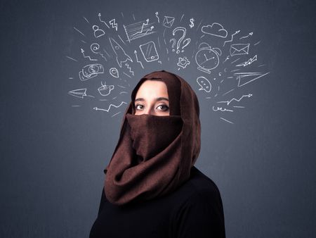 Young muslim woman wearing niqab with mixed white drawings above her head