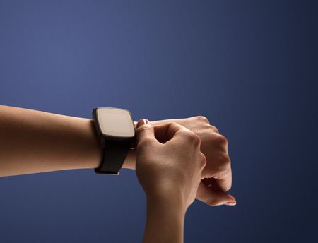 Close up female hand with smartwatch and dark background and black screen