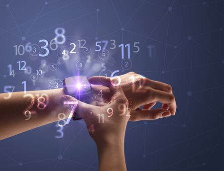 Close up female naked hand wearing smartwatch and numbers around