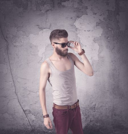 funny-vintage-guy-long-beard-stylish-788435065 Funny vintage guy with long beard and stylish hair standing in front of urban concrete wall concept
