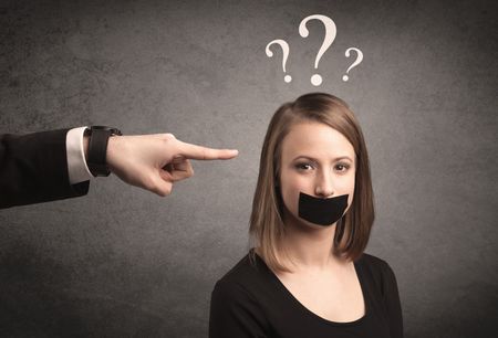 Caucasian business hand pointing at female employee with big white question mark above her head