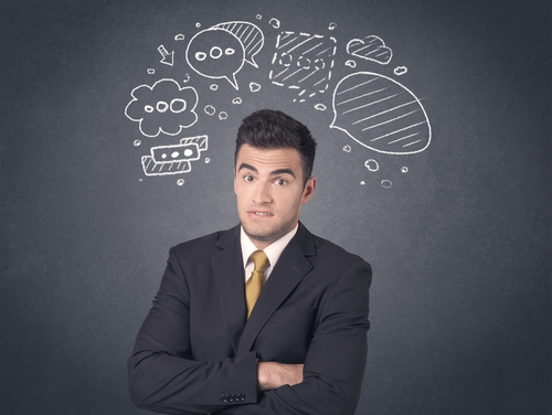 Young businessman with drawn speech bubbles over his head