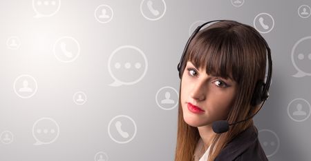 Young female telemarketer with white speech bubbles around her