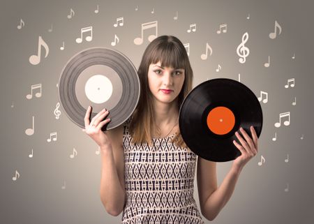Young lady holding vinyl record on a brown background with musical notes behind her