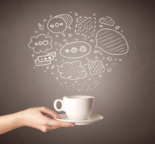 Young female hand holding coffee cup with drawn thought bubbles above it