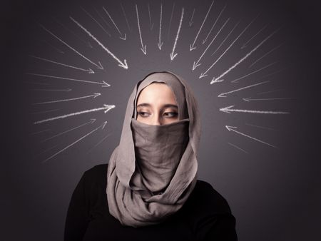 Young muslim woman wearing niqab with white arrows pointing to her head 