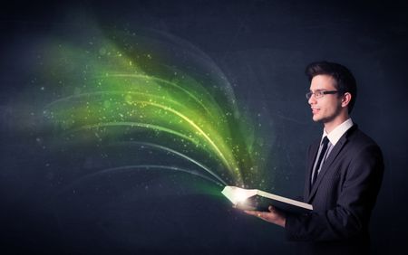 Casual young man holding book with green wave flying out of it