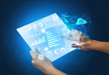 young-female-hand-holding-tablet-blue-789189598 Young female hand holding a tablet with blue graphs