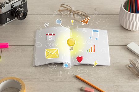 Open notebook on the floor with instruments nearby and icons symbols on it