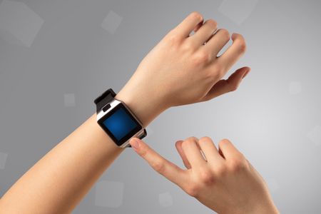 Female hand wearing smartwatch with free space on the screen